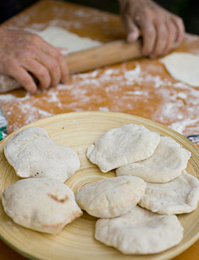 Baking flatbreads in the woodfired clay oven