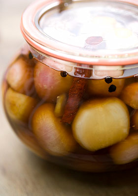 detail of pickled shallots shows cinnamon, chilli and spices in amongst the onions