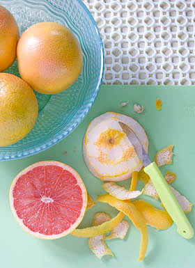 paring the peel from pink grapefruit